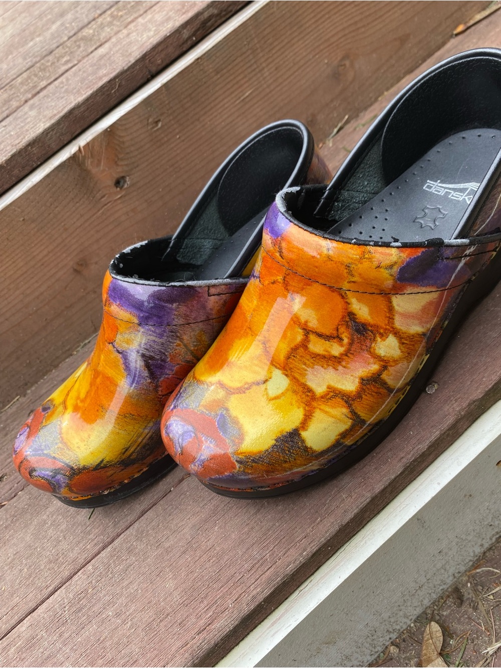Dansko Women’s Yellow Orange Floral Patent Clogs with Purple Accents